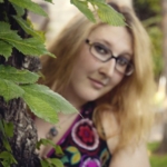Emma posing with tree.